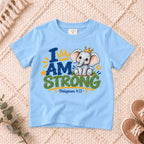 I AM Kids strong design on a Light Blue shirt, shown on a cream rug.