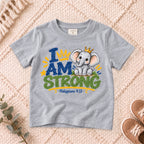 I AM Kids strong design on a Sport Grey shirt, shown on a cream rug.