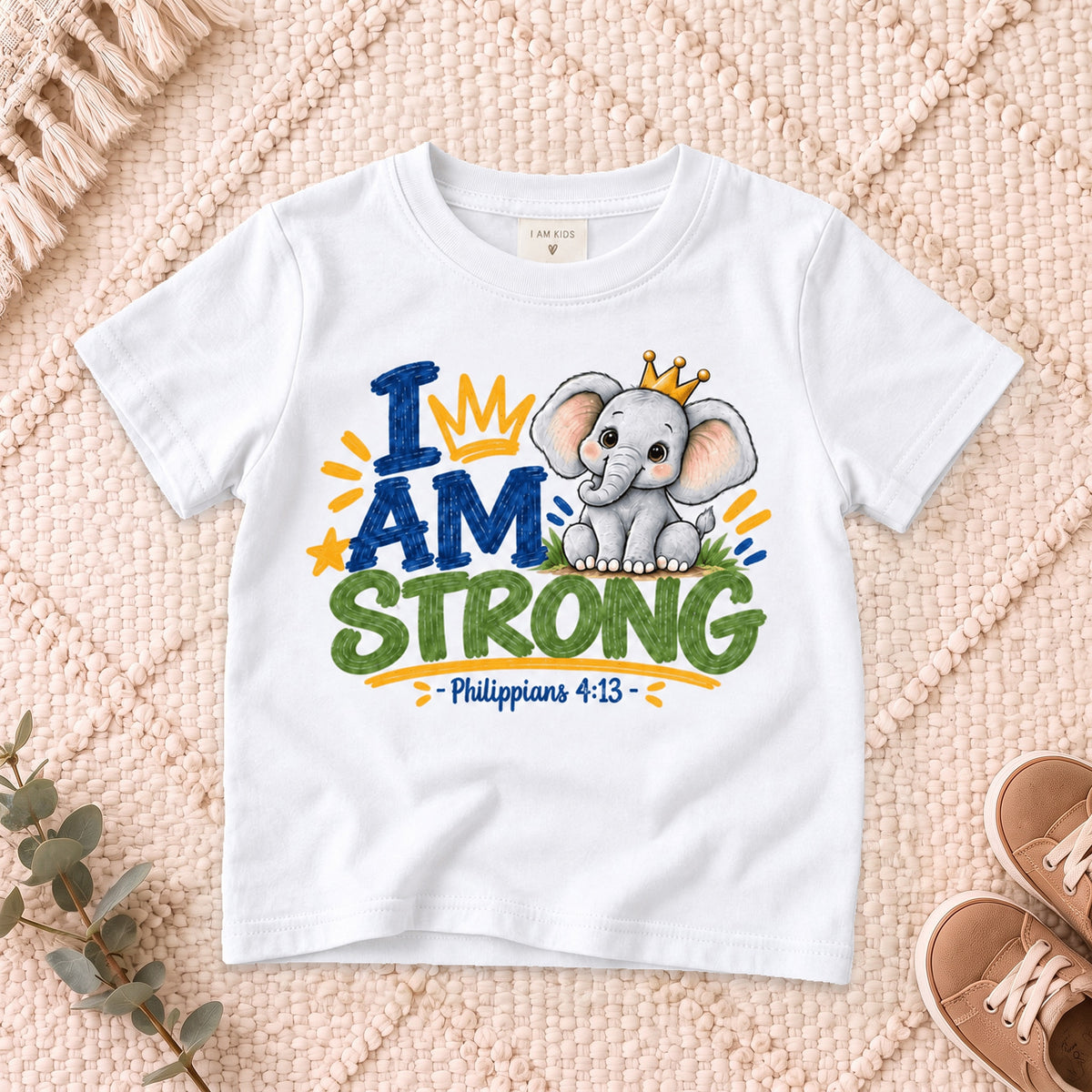 I AM Kids strong design on a White shirt, shown on a cream rug.