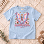 I AM Kids 1Butterfly1 design on a Light Blue shirt, shown on a cream rug.
