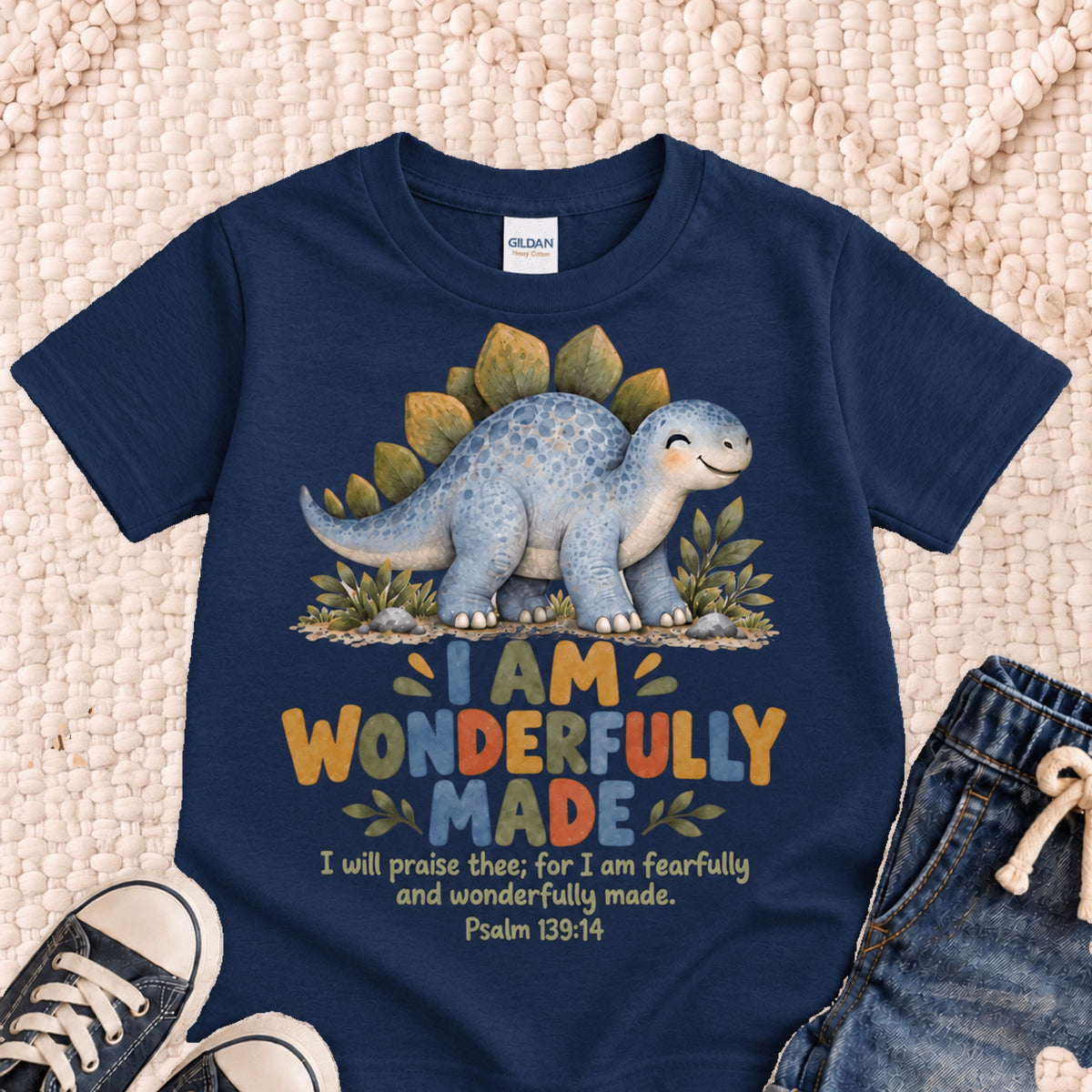 I AM Kids dino wonderful design on a Navy shirt, shown on a cream rug.