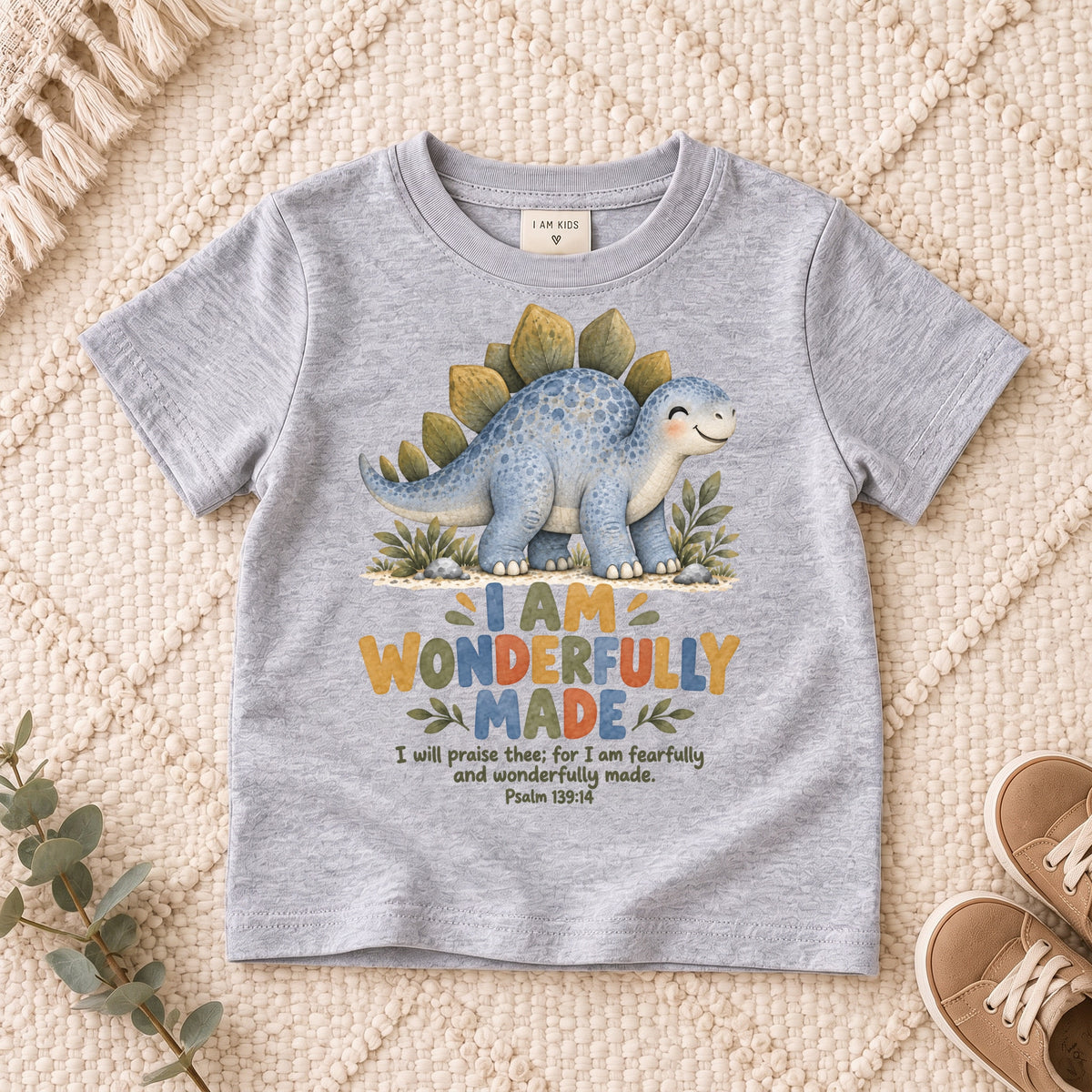 I AM Kids dino wonderful design on a Sport Grey shirt, shown on a cream rug.