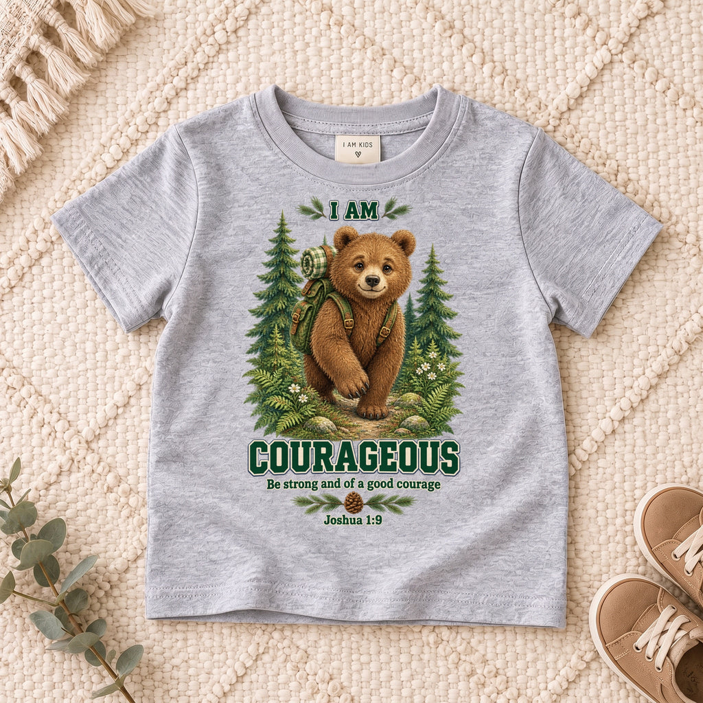I AM COURAGEOUS woodland bear design on a Sport Grey kids shirt, photographed on a cream rug.