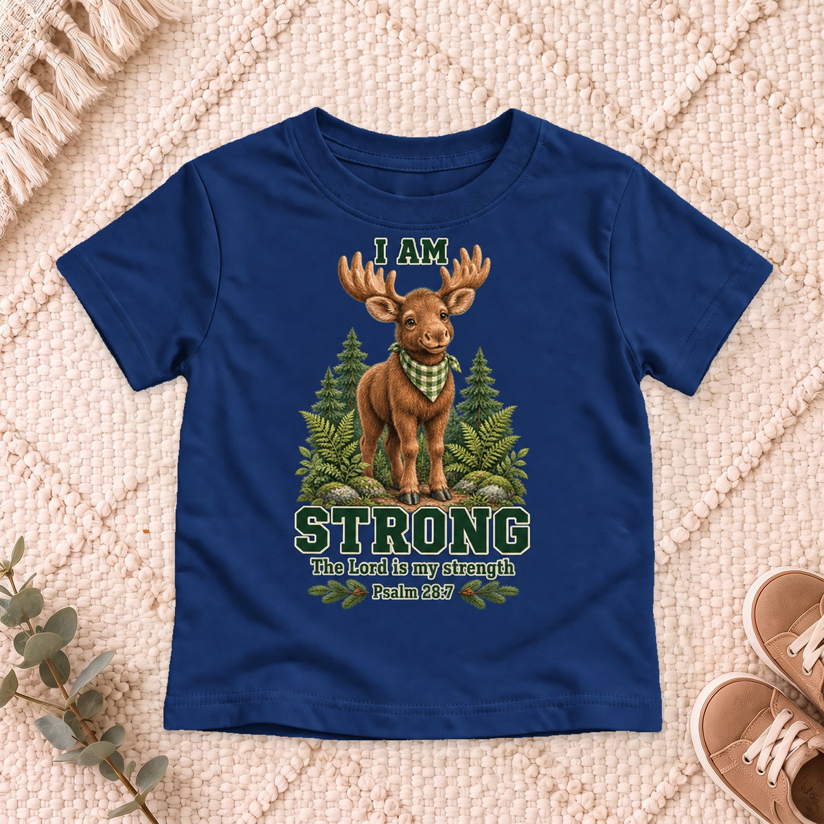 I AM Kids moose design on a Navy shirt, shown on a cream rug.