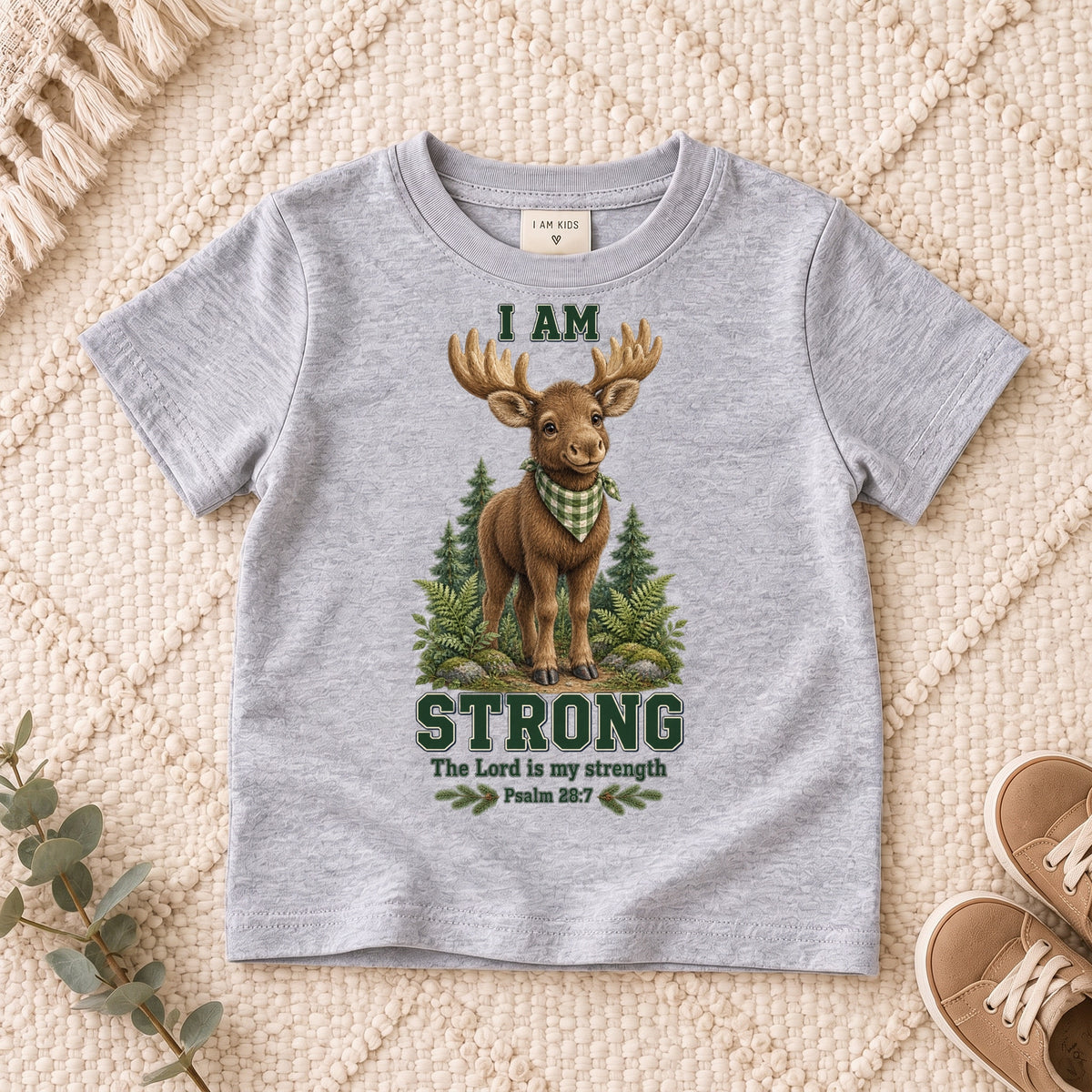 I AM Kids moose design on a Sport Grey shirt, shown on a cream rug.