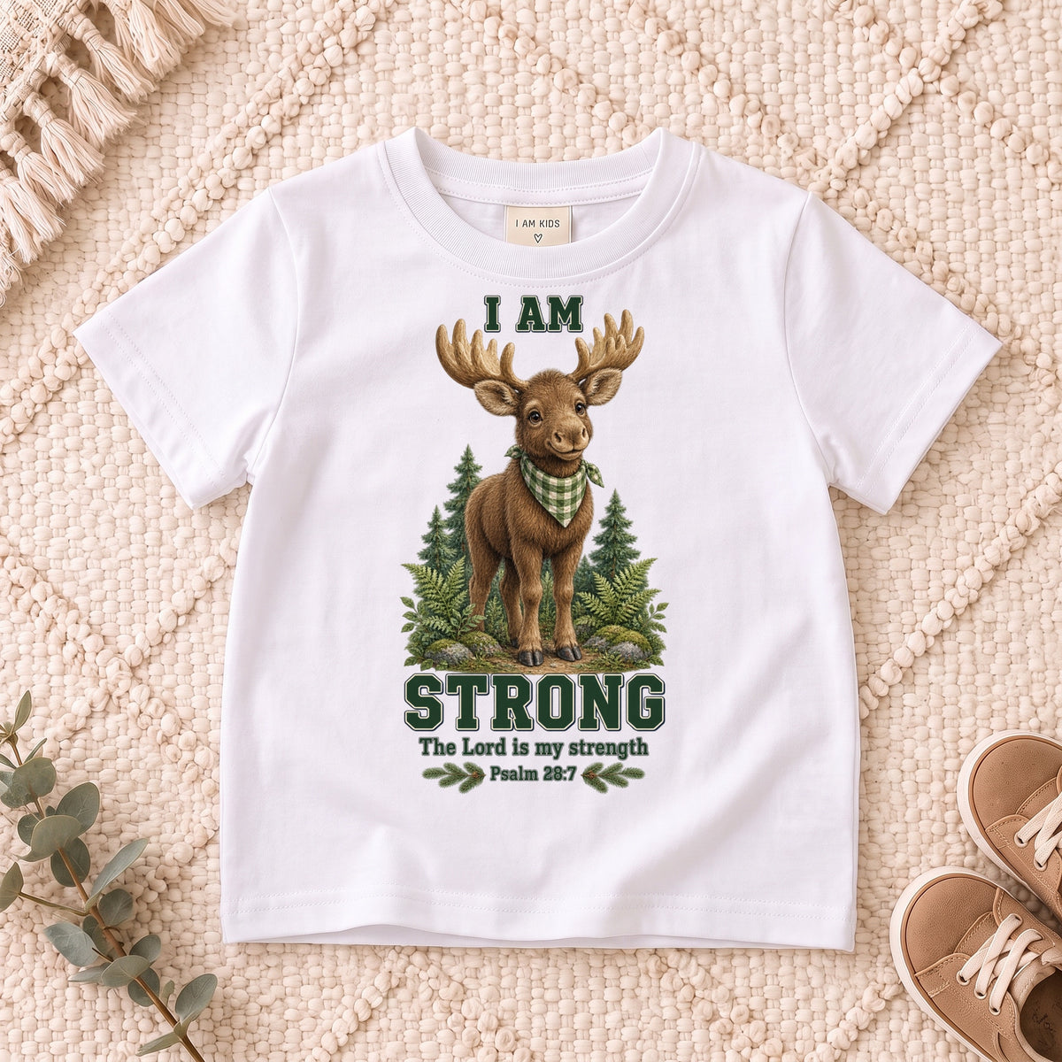 I AM Kids moose design on a White shirt, shown on a cream rug.