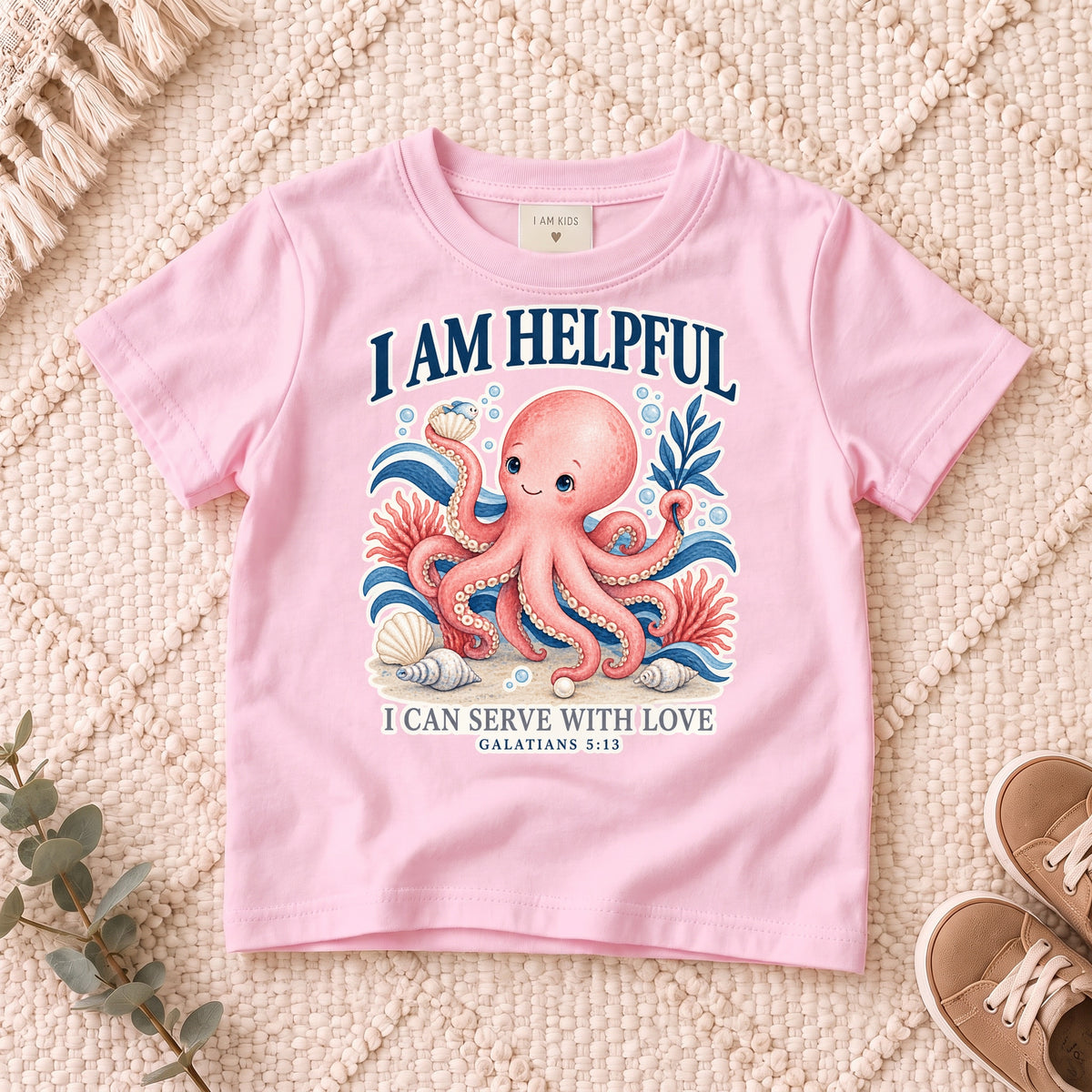 I AM Kids octopus design on a Light Pink shirt, shown on a cream rug.