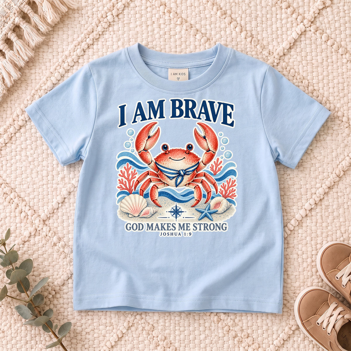 I AM Kids crab design on a Light Blue shirt, shown on a cream rug.