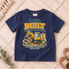 I AM Kids built truck design on a Navy shirt, shown on a cream rug.
