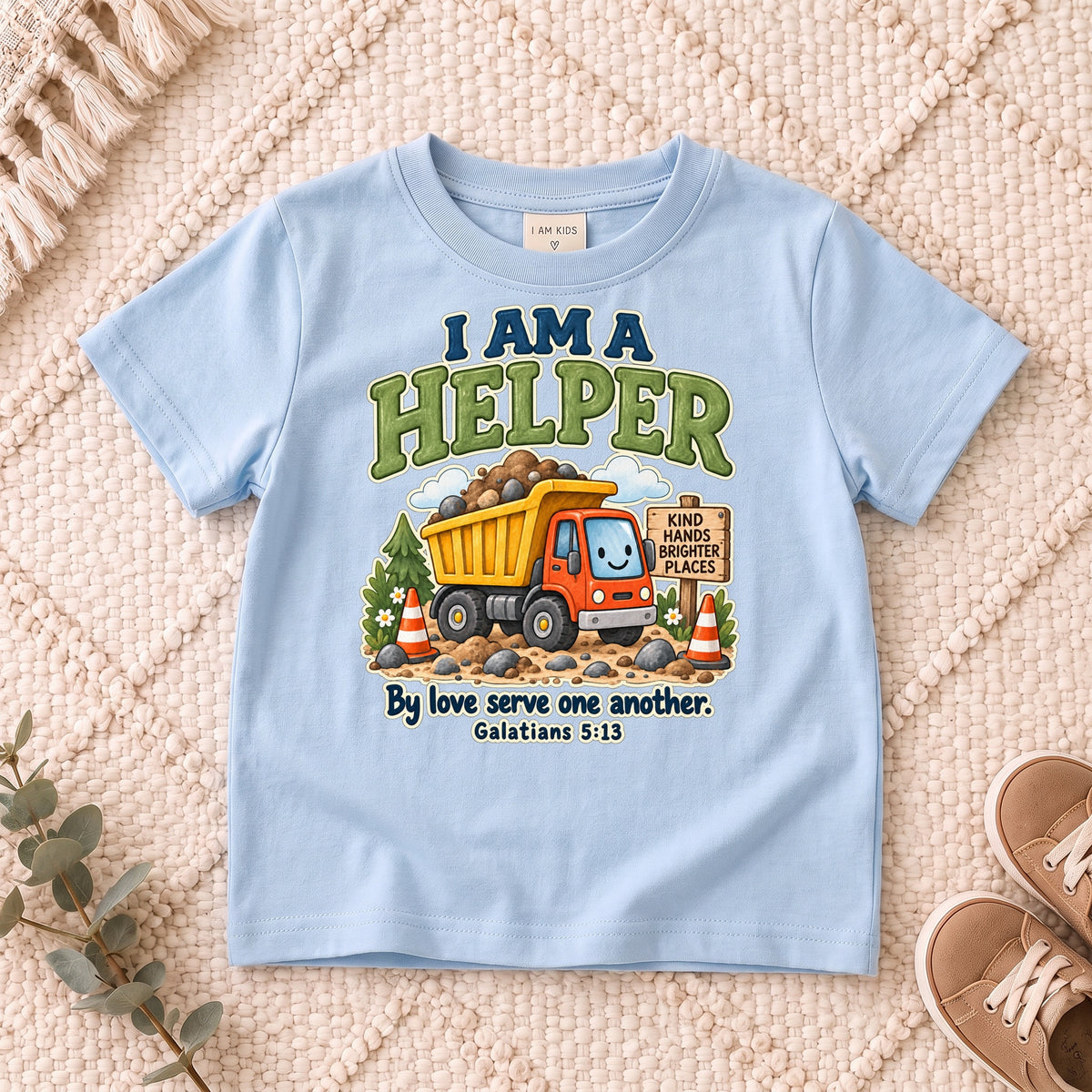 I AM Kids helper truck design on a Light Blue shirt, shown on a cream rug.