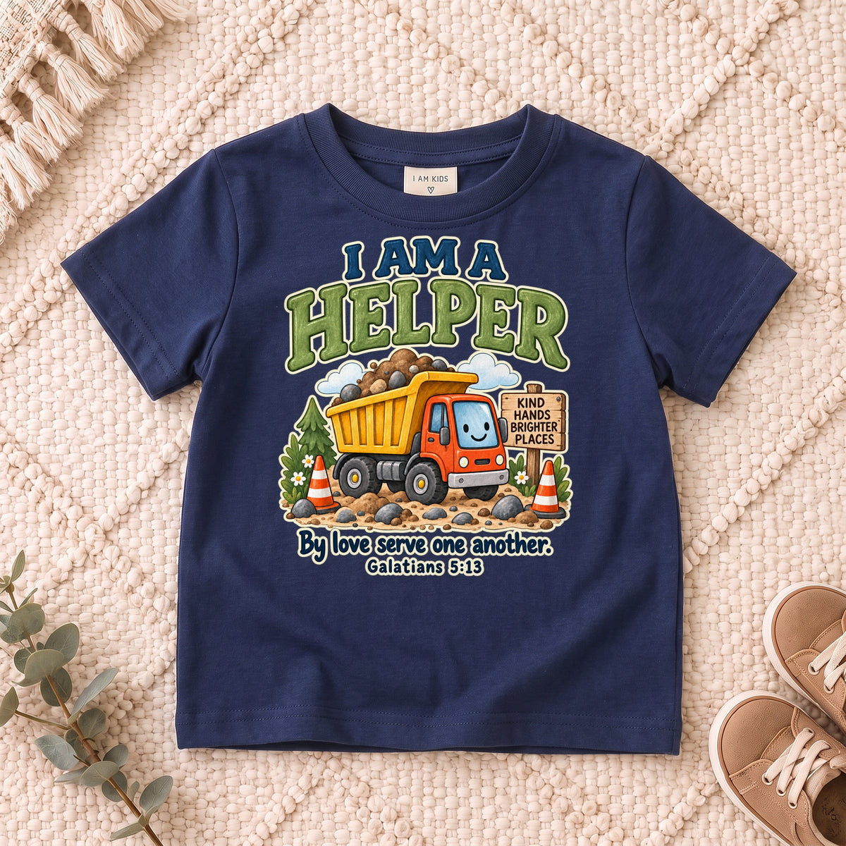 I AM Kids helper truck design on a Navy shirt, shown on a cream rug.
