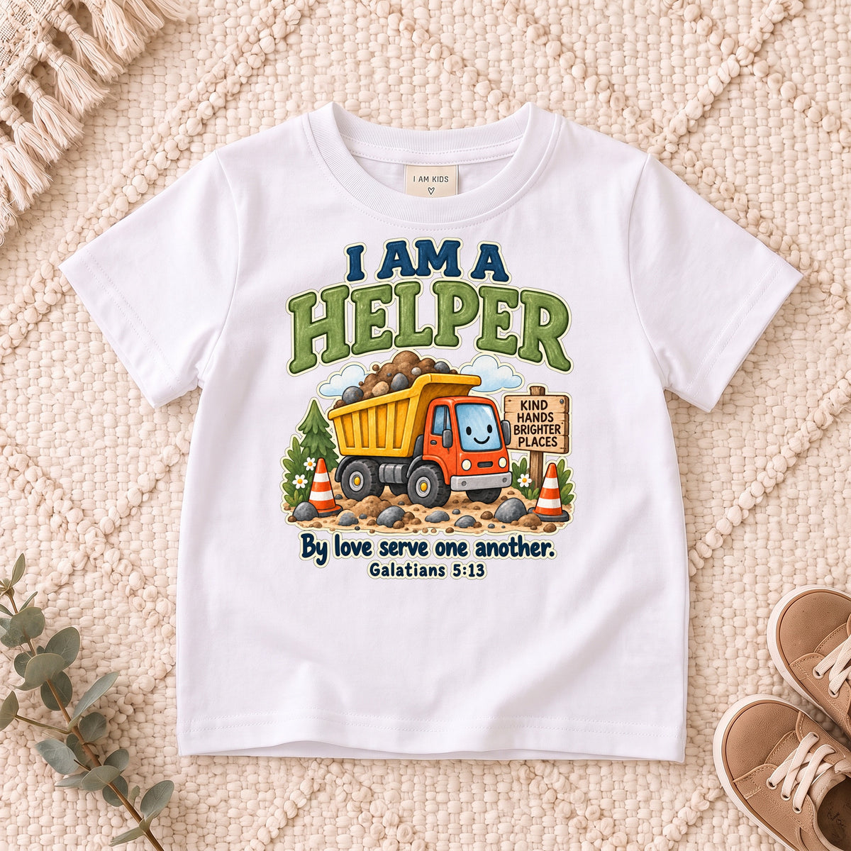 I AM Kids helper truck design on a White shirt, shown on a cream rug.