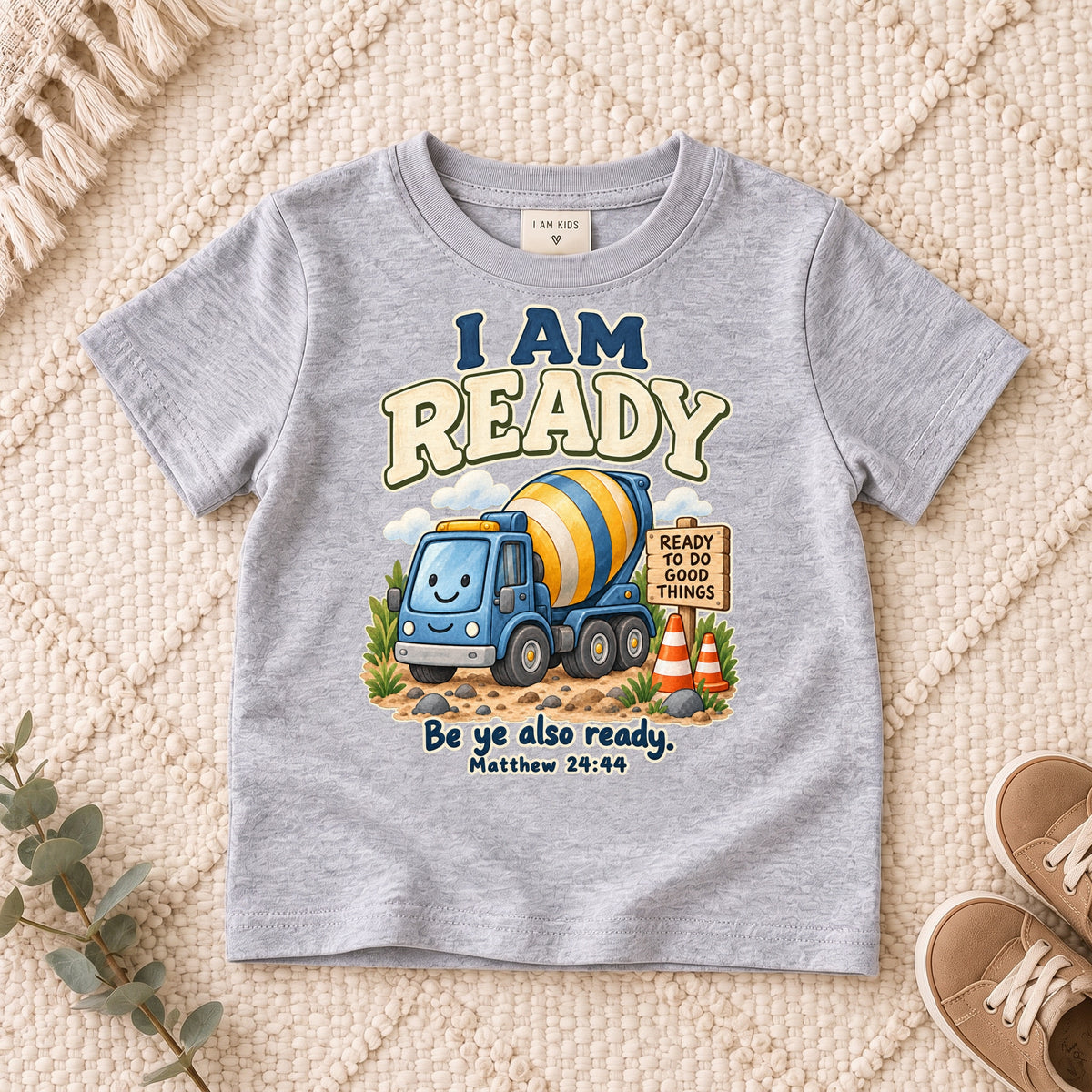 I AM Kids ready truck design on a Sport Grey shirt, shown on a cream rug.