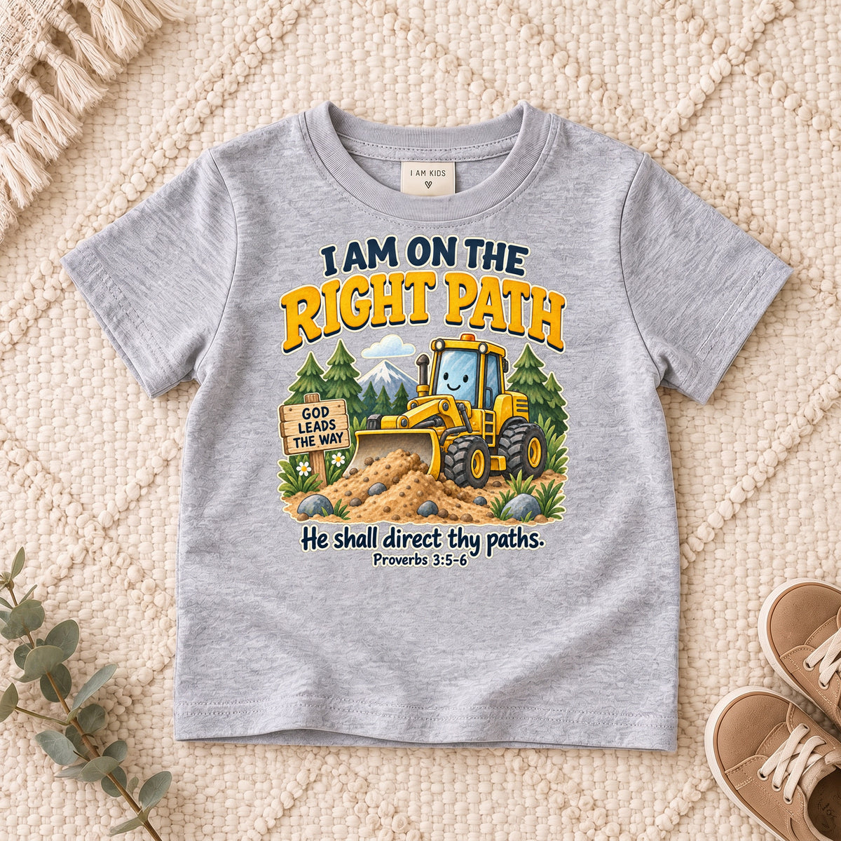 I AM Kids truck path design on a Sport Grey shirt, shown on a cream rug.