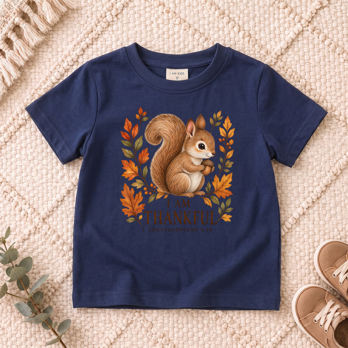 I AM Kids squirrel design on a Navy shirt, shown on a cream rug.