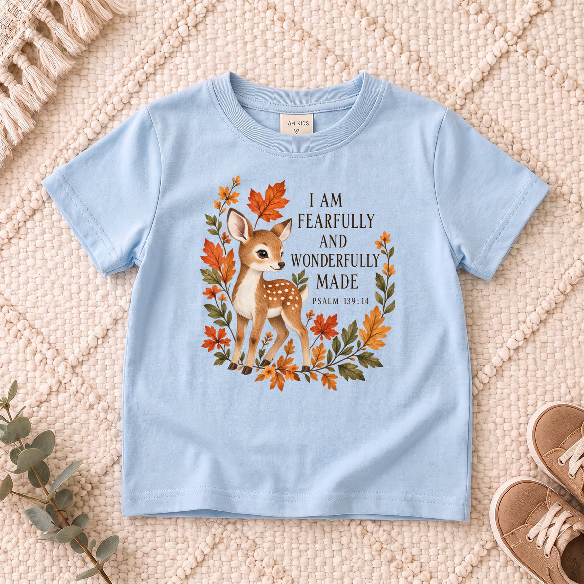 I AM Kids Deer design on a Light Blue shirt, shown on a cream rug.