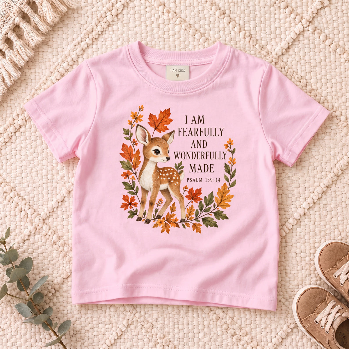 I AM Kids Deer design on a Light Pink shirt, shown on a cream rug.