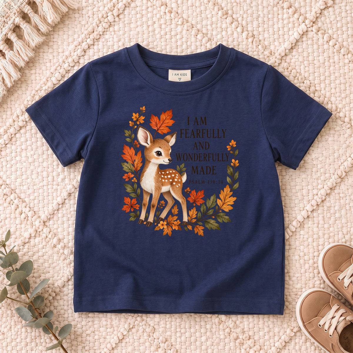 I AM Kids Deer design on a Navy shirt, shown on a cream rug.