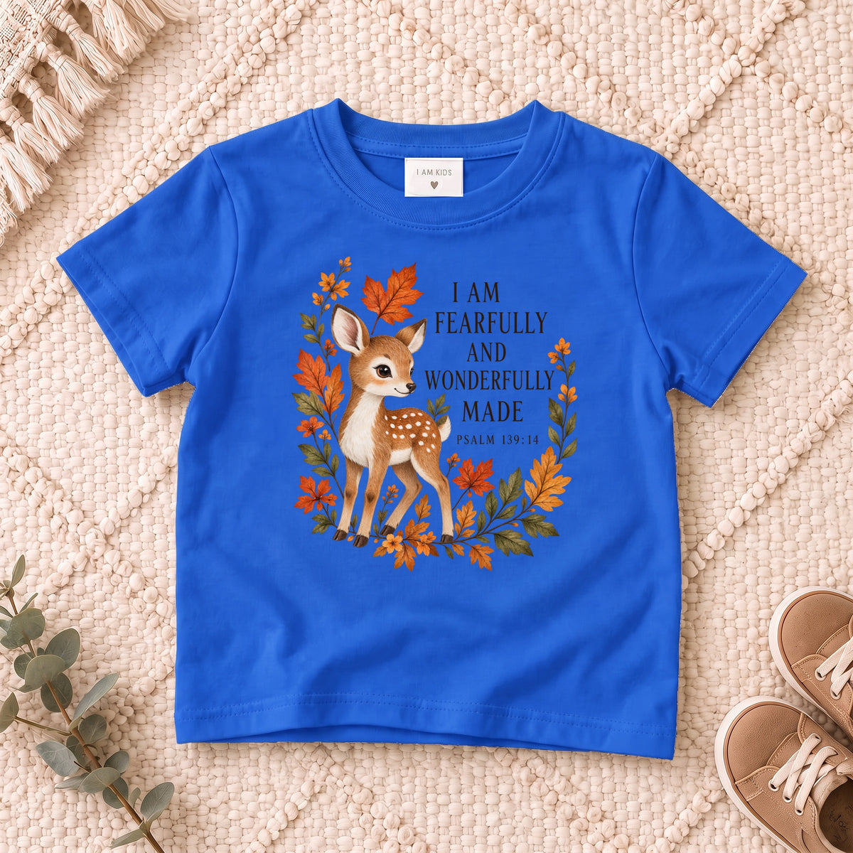 I AM Kids Deer design on a Royal shirt, shown on a cream rug.