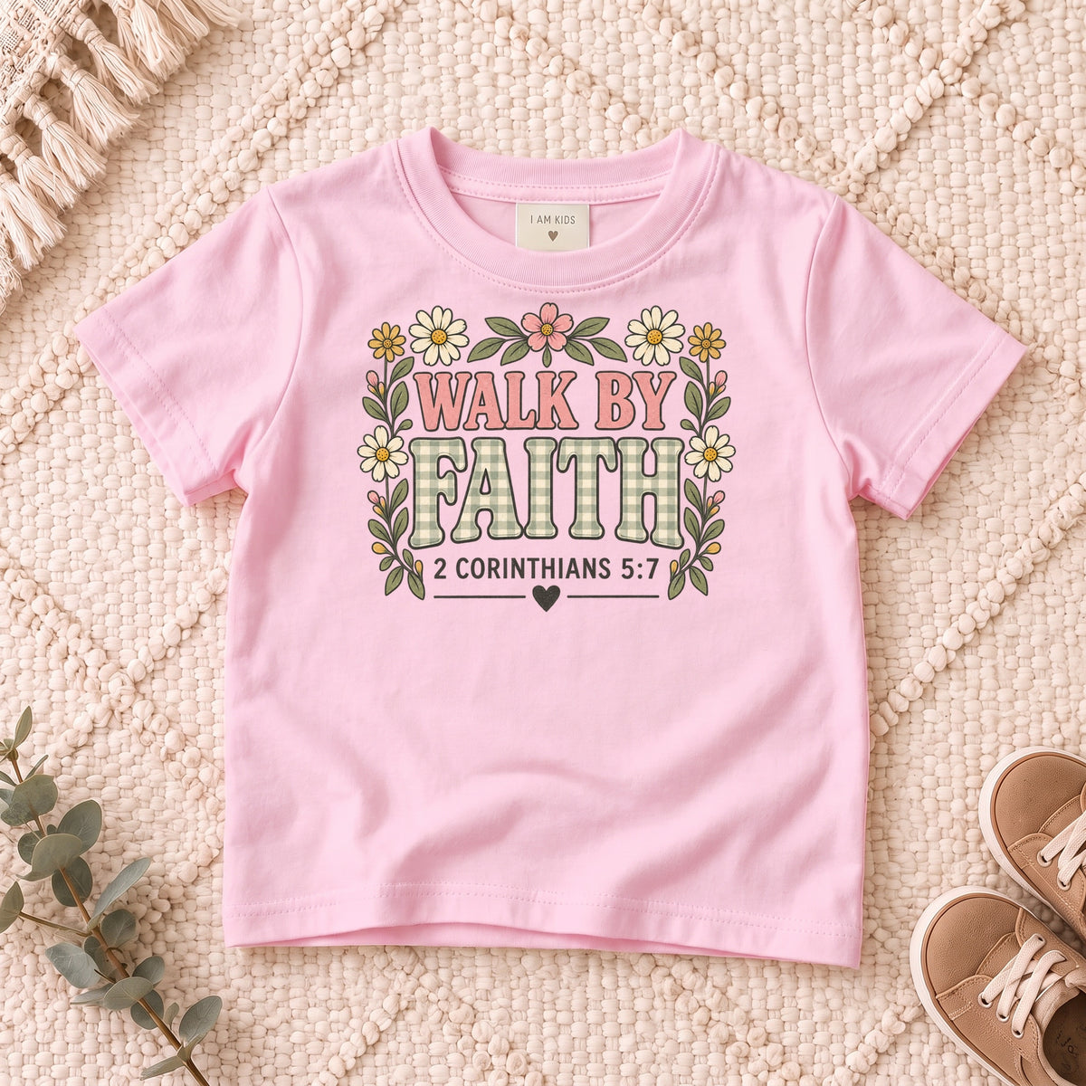 I AM Kids walk by faith bow design on a Light Pink shirt, shown on a cream rug.