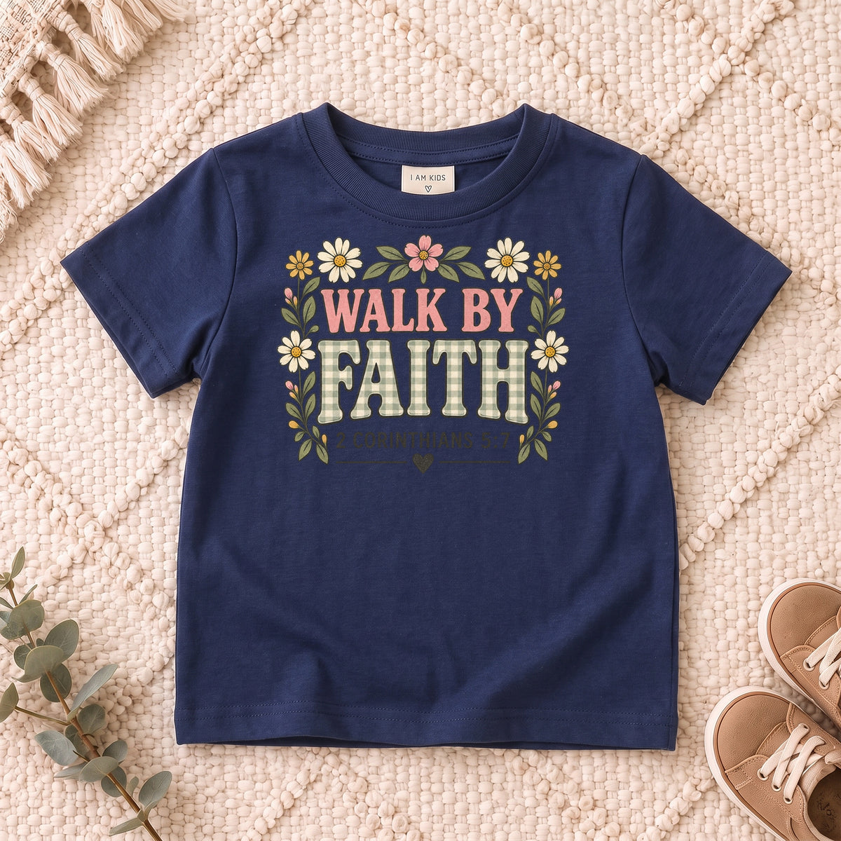 I AM Kids walk by faith bow design on a Navy shirt, shown on a cream rug.