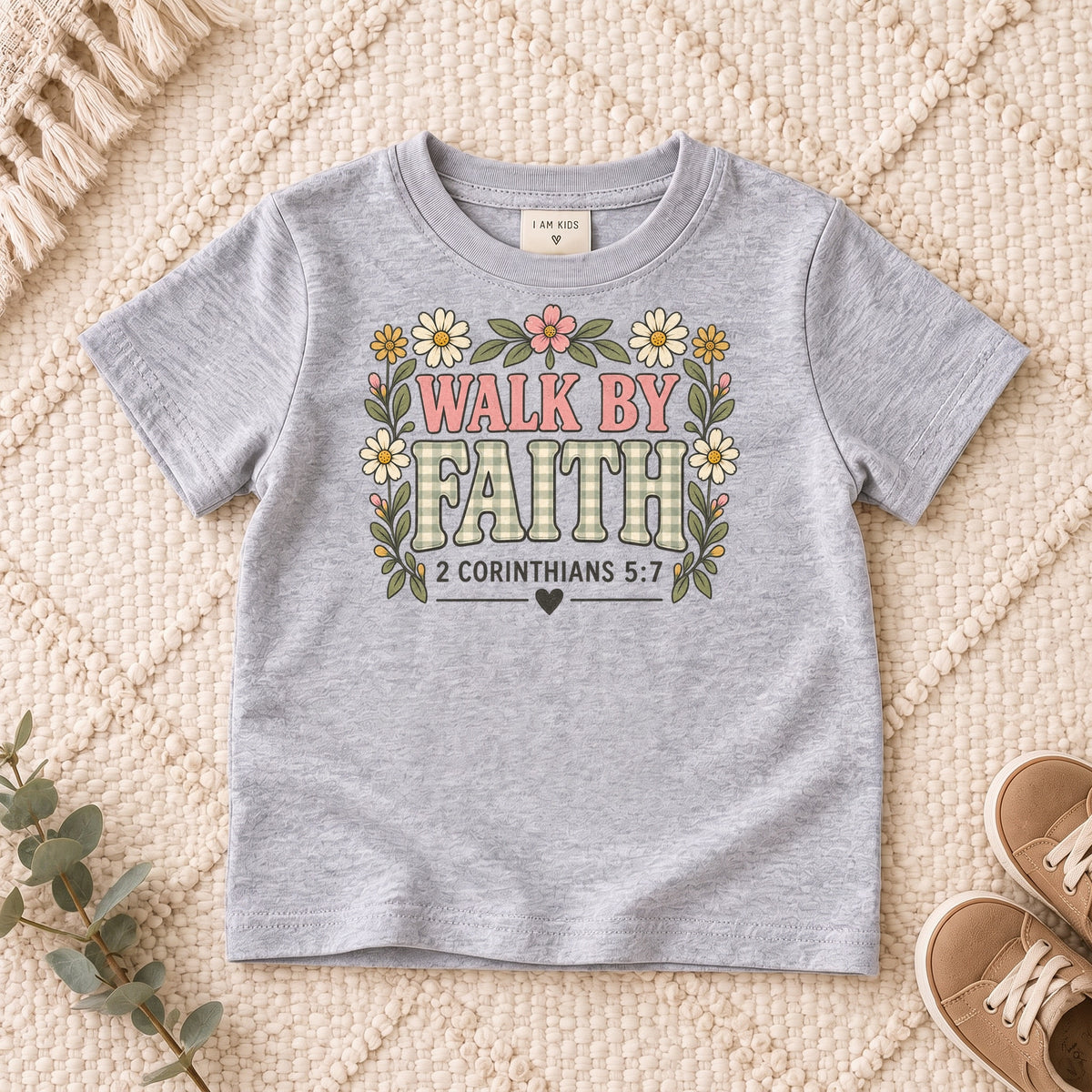 I AM Kids walk by faith bow design on a Sport Grey shirt, shown on a cream rug.