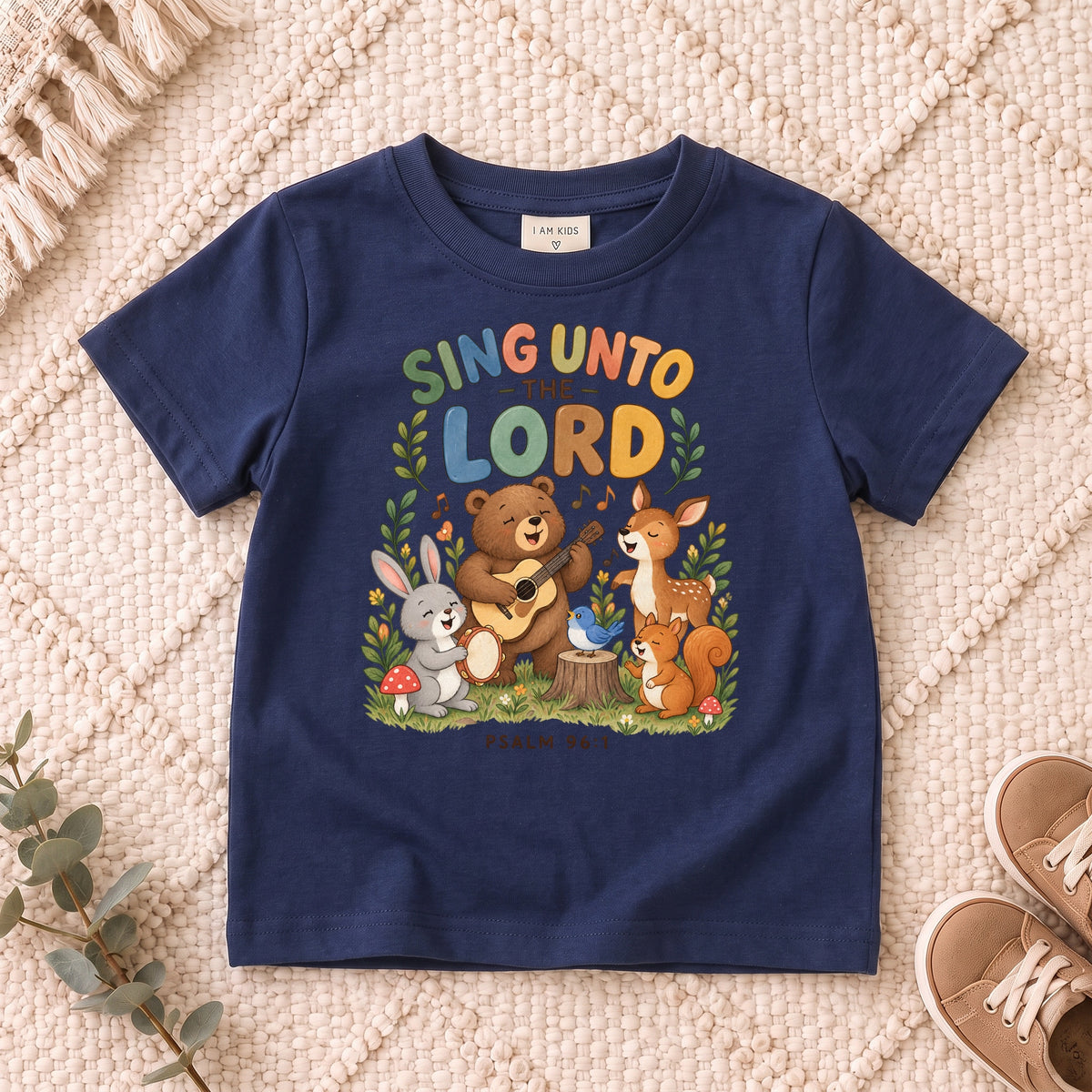 I AM Kids sing bear design on a Navy shirt, shown on a cream rug.