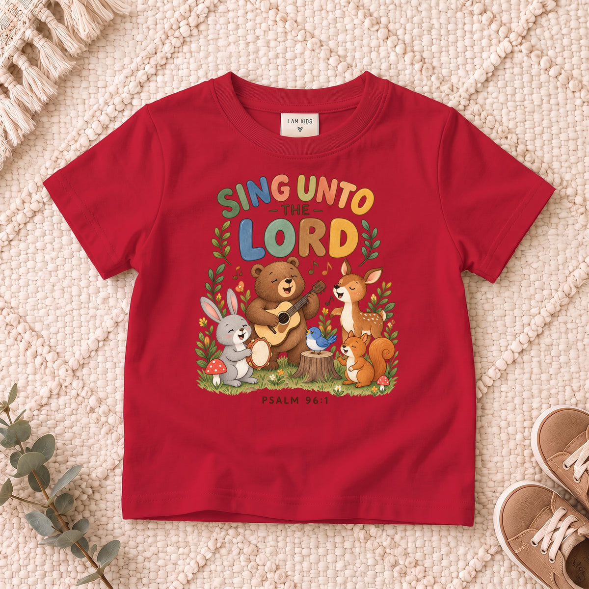 I AM Kids sing bear design on a Red shirt, shown on a cream rug.