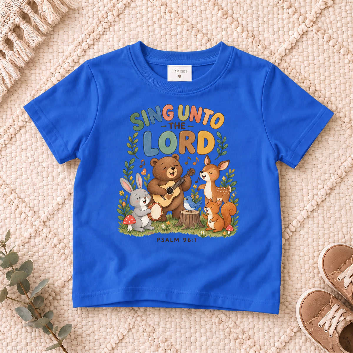 I AM Kids sing bear design on a Royal shirt, shown on a cream rug.