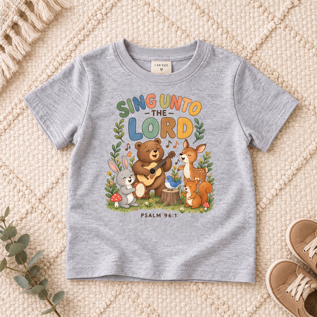 I AM Kids sing bear design on a Sport Grey shirt, shown on a cream rug.