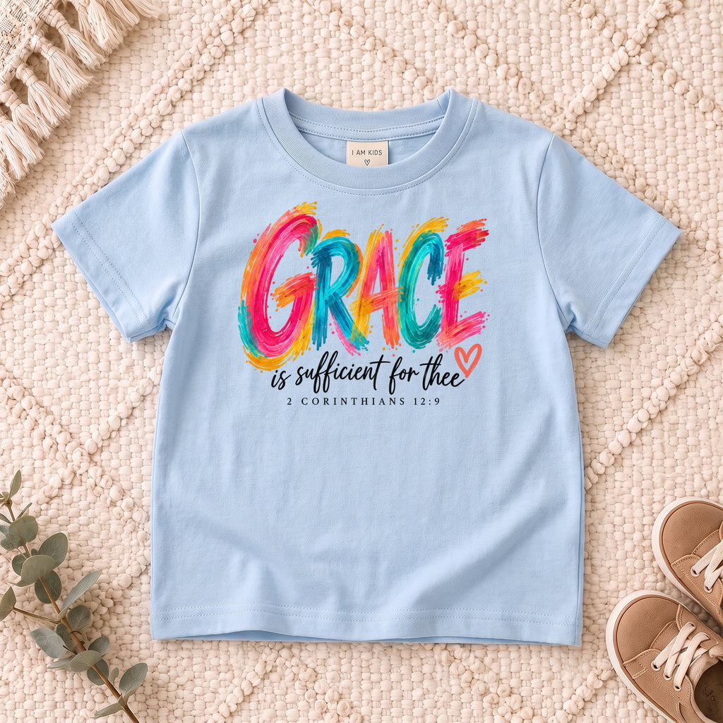 I AM Kids grace design on a Light Blue shirt, shown on a cream rug.