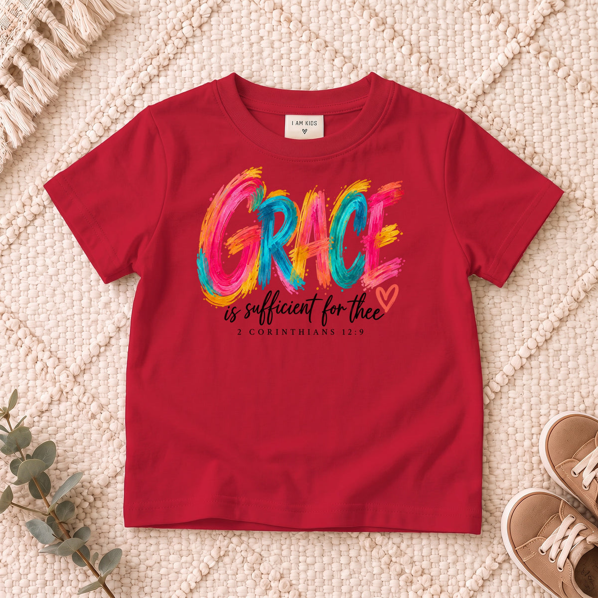 I AM Kids grace design on a Red shirt, shown on a cream rug.