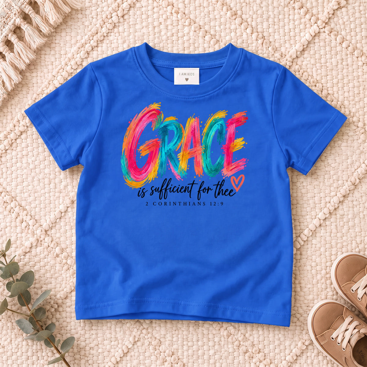 I AM Kids grace design on a Royal shirt, shown on a cream rug.