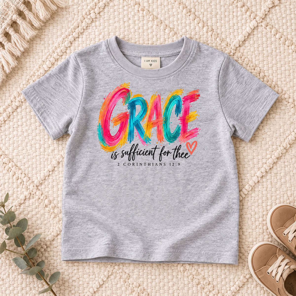I AM Kids grace design on a Sport Grey shirt, shown on a cream rug.