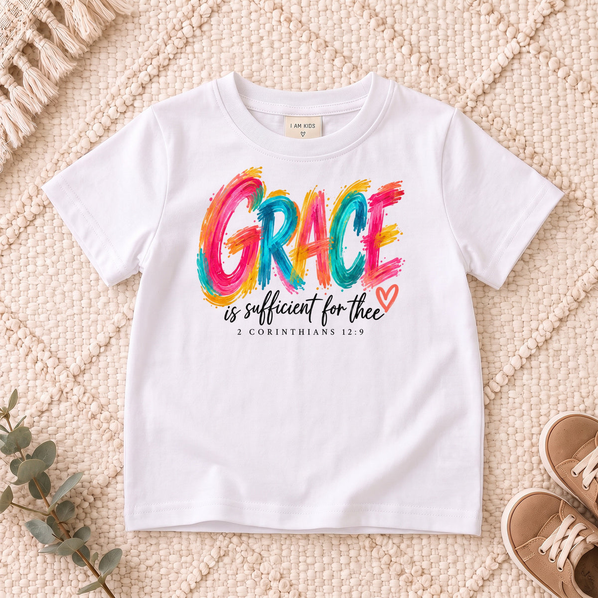 I AM Kids grace design on a White shirt, shown on a cream rug.