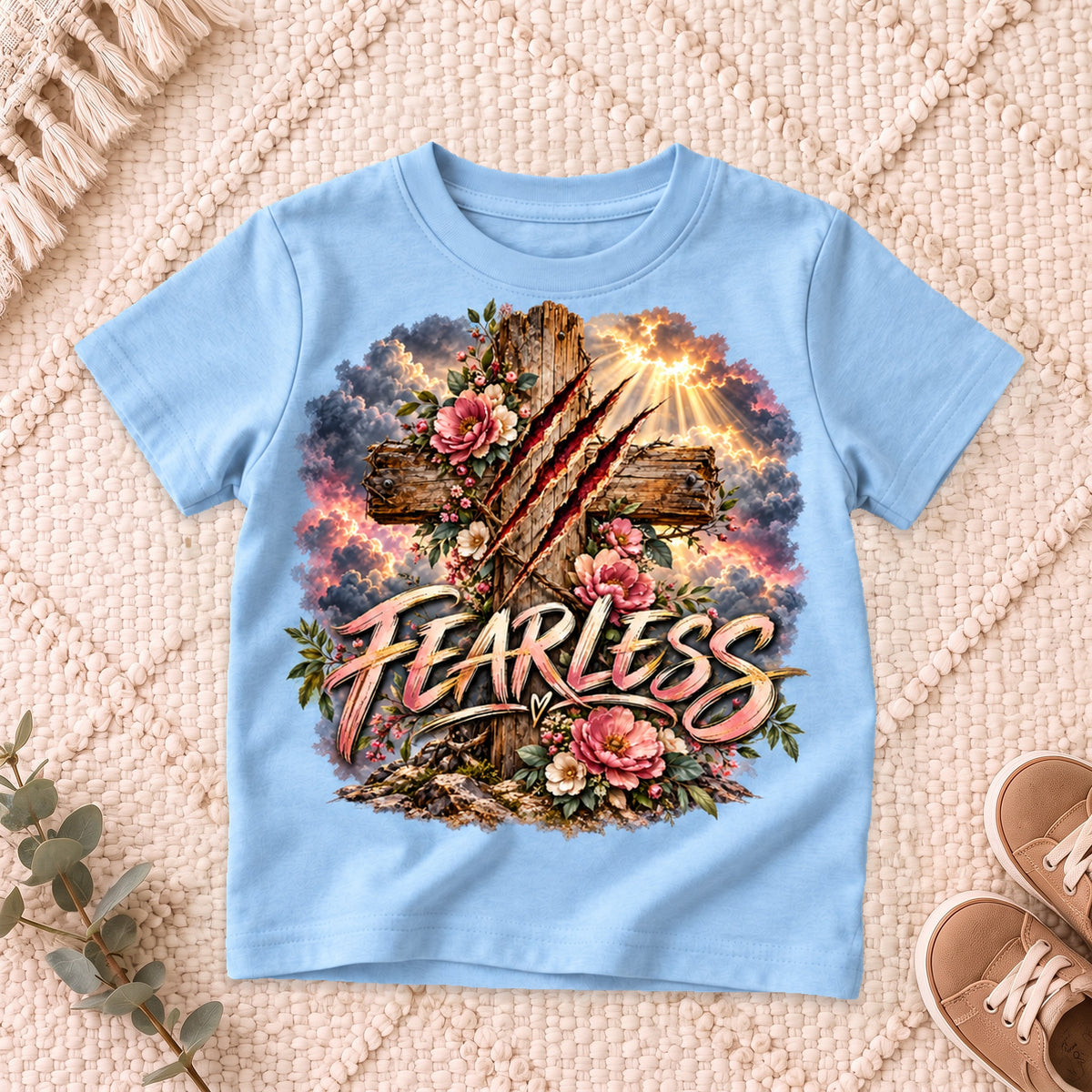 I AM Kids Floral FEARLESS Cross Kids Tee design on a Light Blue shirt, shown on a cream rug.