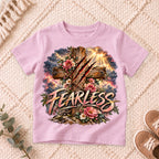 I AM Kids Floral FEARLESS Cross Kids Tee design on a Light Pink shirt, shown on a cream rug.