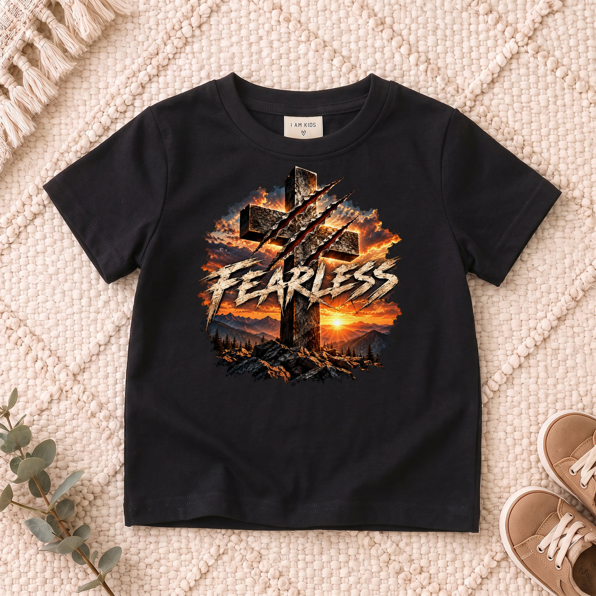 I AM Kids FEARLESS Cross Kids Tee design on a Black shirt, shown on a cream rug.