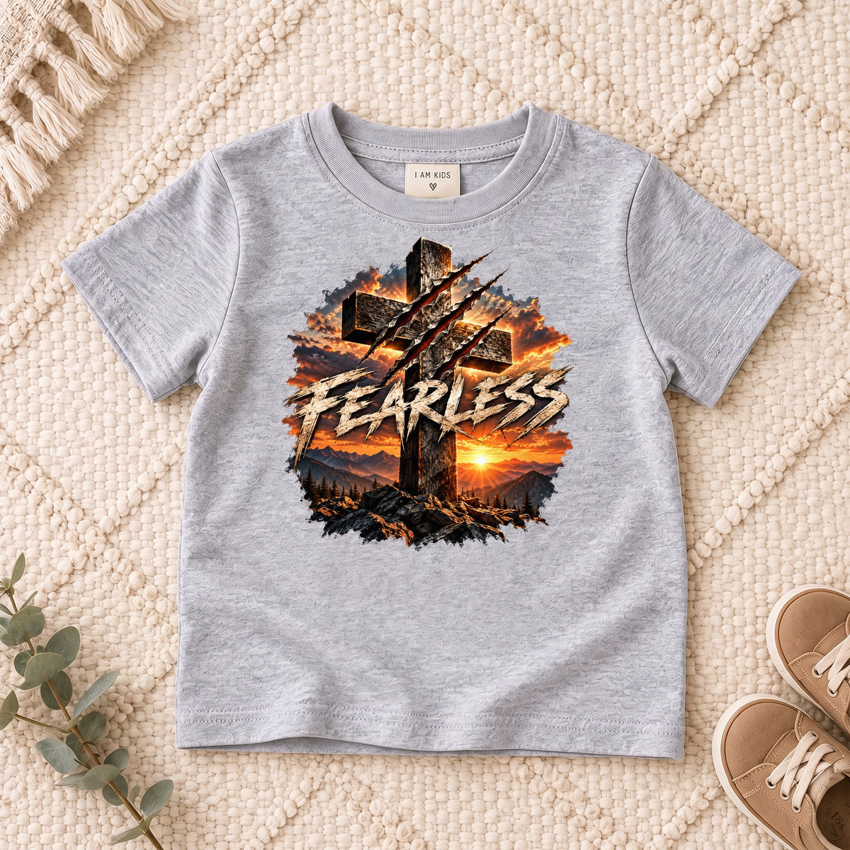 I AM Kids FEARLESS Cross Kids Tee design on a Sport Grey shirt, shown on a cream rug.