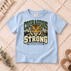 I AM Kids Be Strong & Courageous Tiger Kids Tee design on a Light Blue shirt, shown on a cream rug.
