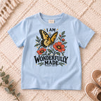 I AM Kids I AM Wonderfully Made Butterfly Kids Tee | Psalm 139:14 design on a Light Blue shirt, shown on a cream rug.