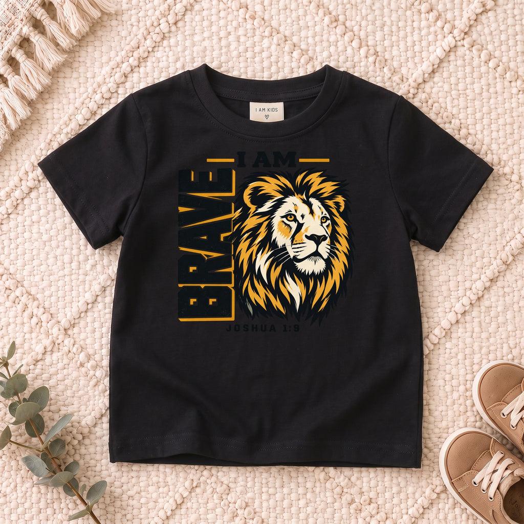 I AM Kids I AM Brave Lion Kids Tee | Joshua 1:9 design on a Black shirt, shown on a cream rug.