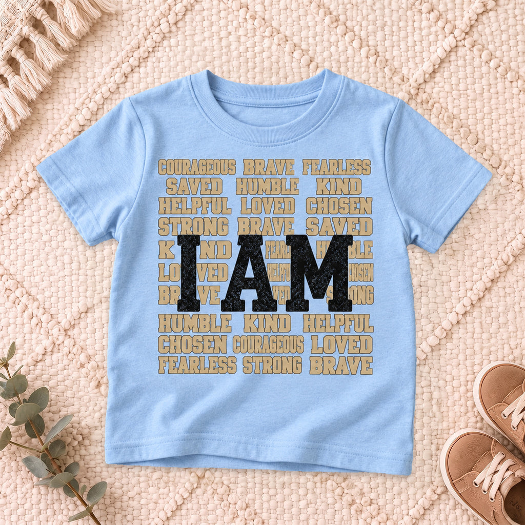 I AM Kids I AM Words of Faith Kids Tee design on a Light Blue shirt, shown on a cream rug.