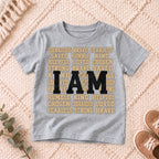 I AM Kids I AM Words of Faith Kids Tee design on a Sport Grey shirt, shown on a cream rug.