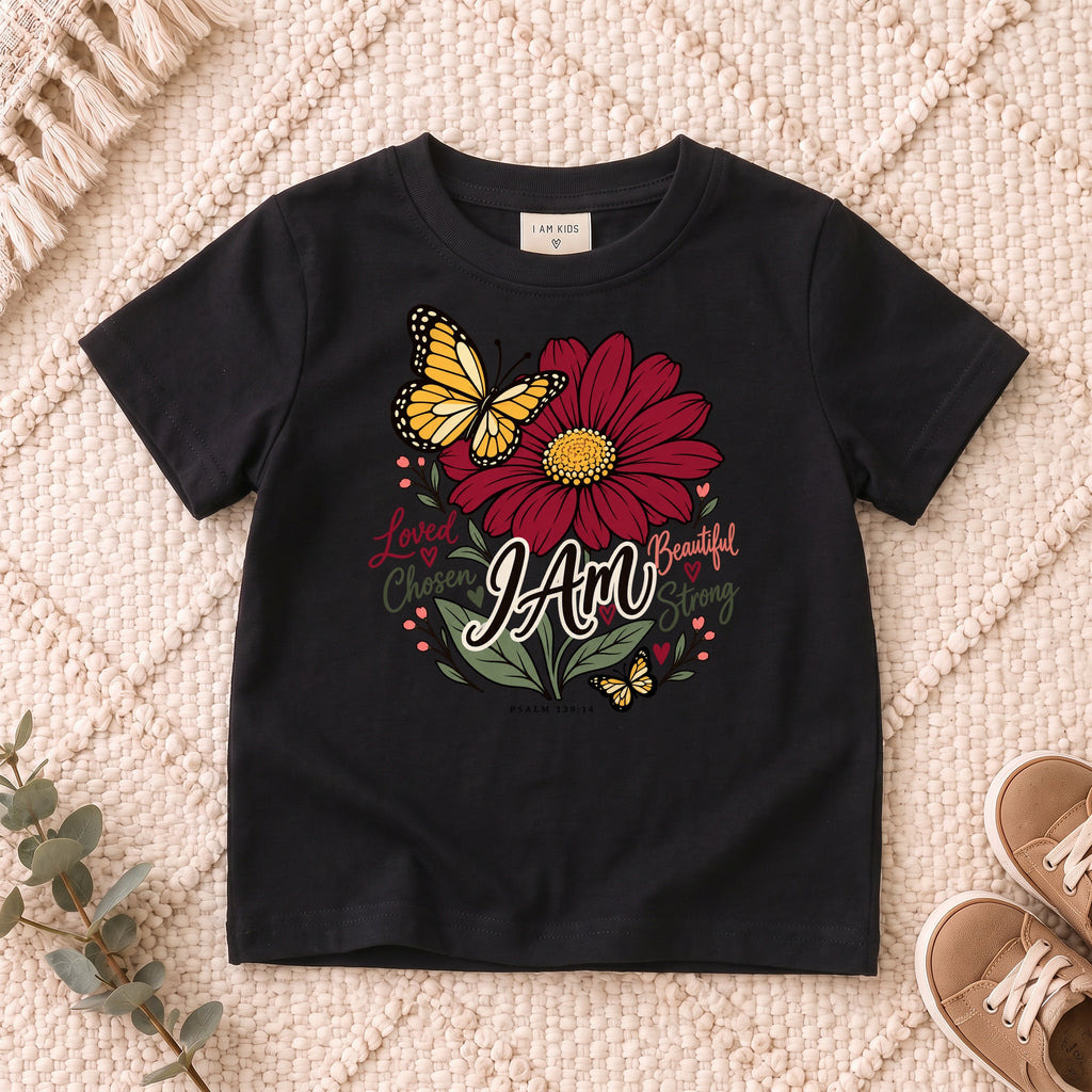 I AM Kids I AM Loved & Chosen Burgundy Flower Kids Tee | Psalm 139:14 design on a Black shirt, shown on a cream rug.